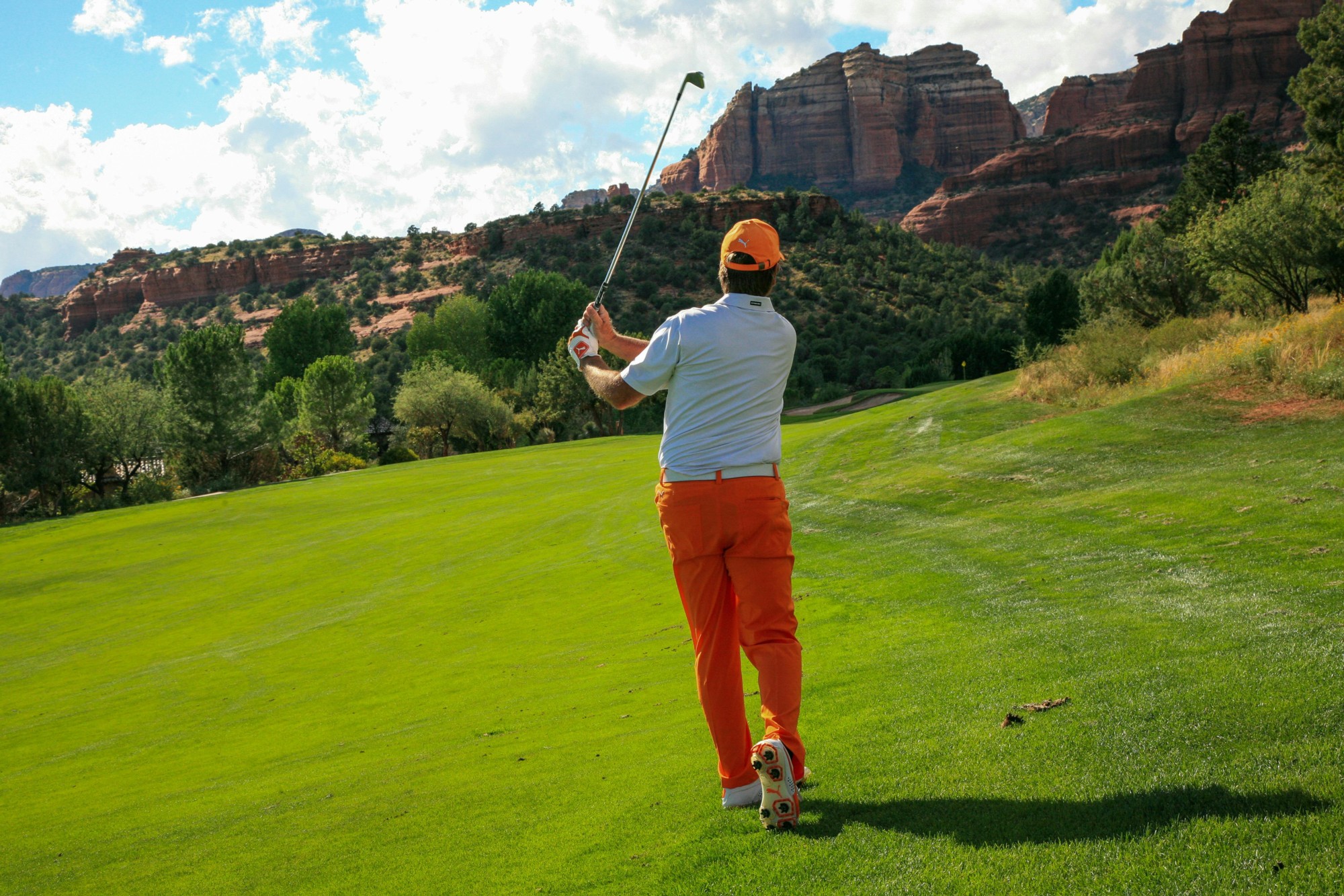 Man hitting a golf ball on a golf course